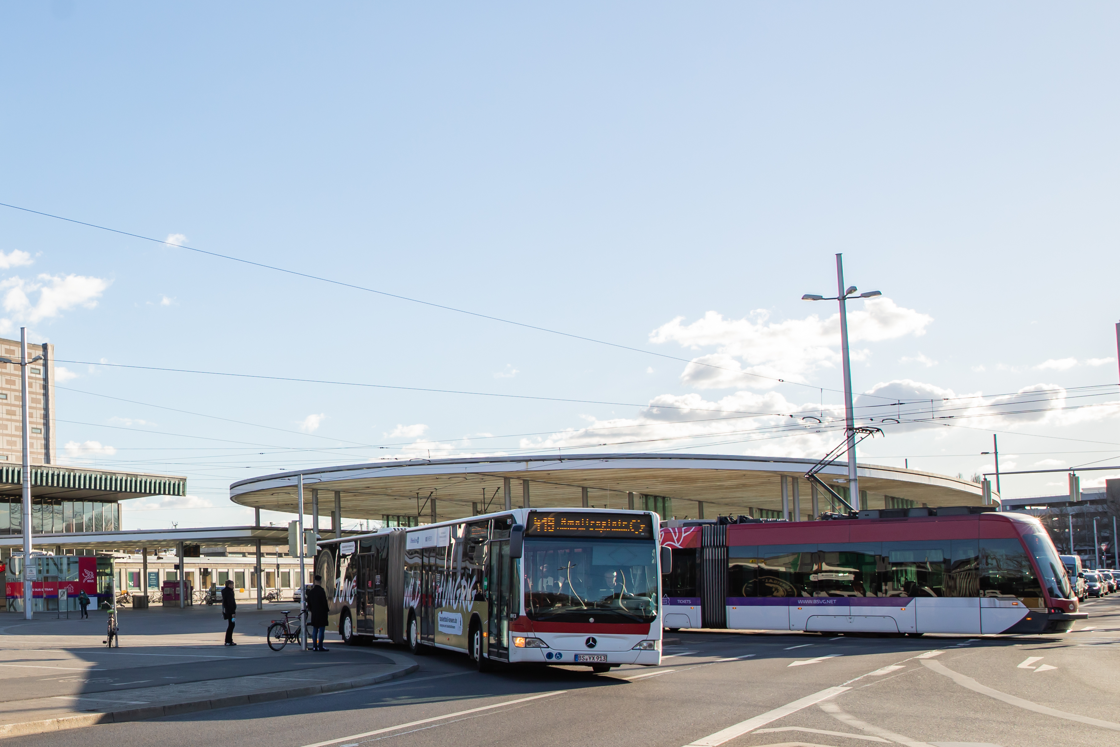 Ein Bus und eine Stadtbahn der BSVG fahren von der Haltestelle am Braunschweiger Hauptbahnhof ab.